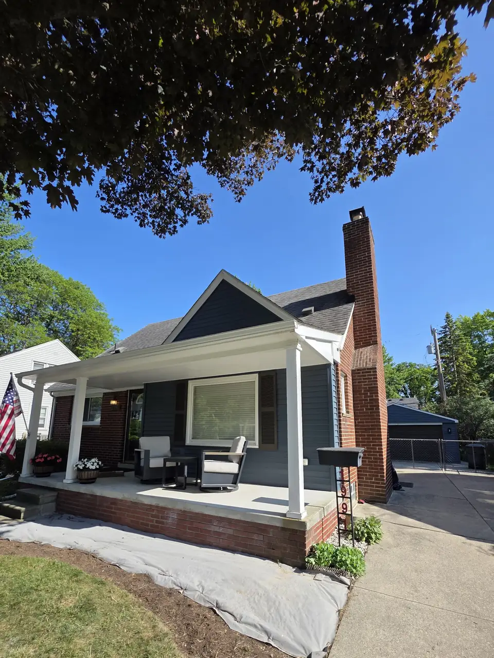 Navy bungalow with bright white porch columns and trim