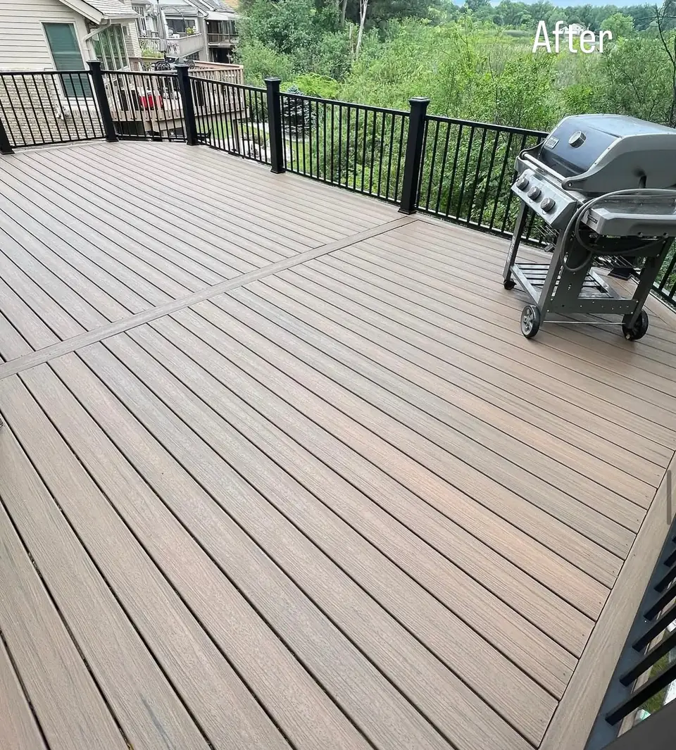 Finished backyard deck with black metal railings