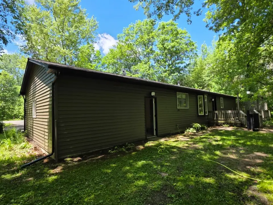 Ranch home with deep green painted siding